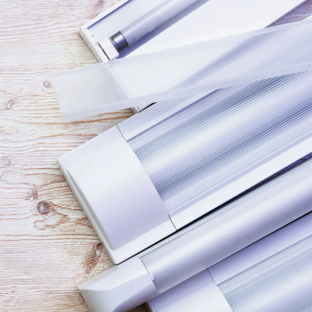 A stack of shop tube lights that can be used for growing healthy tomato seedlings.