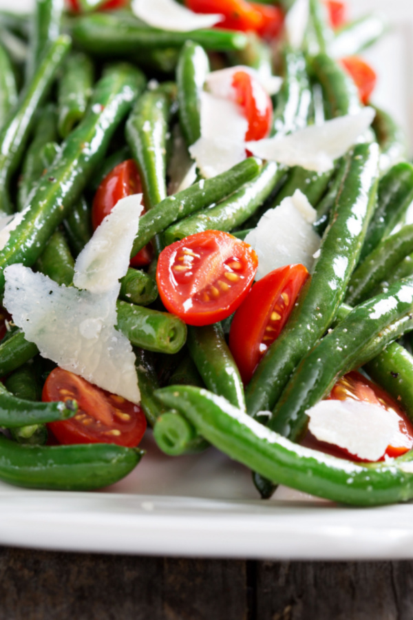 shaved Parmesan cheese on skillet green beans and tomatoes