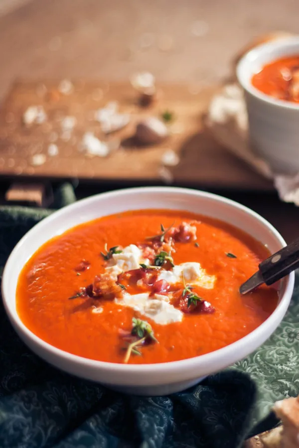 Irish tomato soup garnished with bacon and melted blue cheese