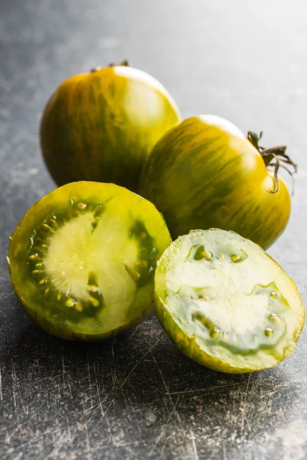 A sliced Green Zebra tomato with the seeds showing