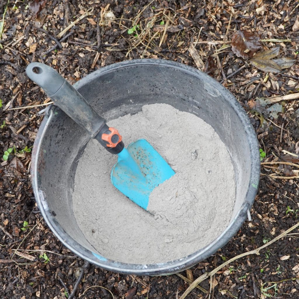 A bucket of wood ash and a shovel