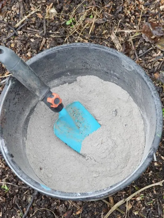 A pale of wood ash for tomato plants