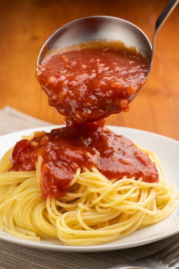 ladle spaghetti sauce over pasta