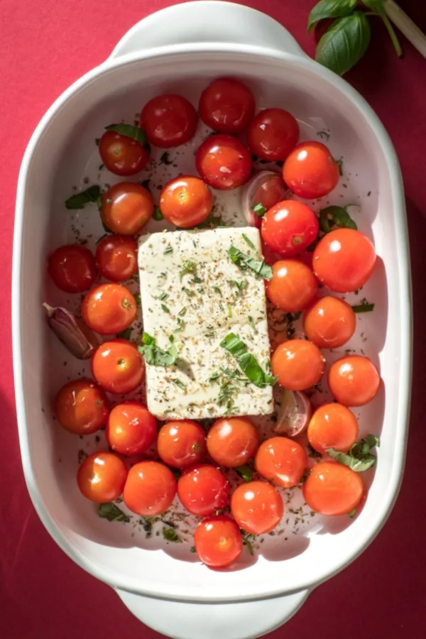 cherry tomatoes and cheese in baking dish